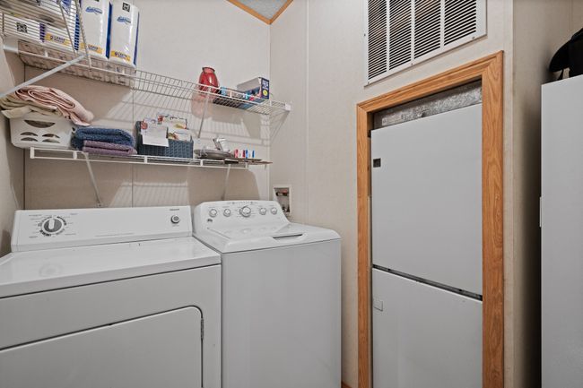 Laundry room with washer and clothes dryer and room for a freezer | Image 16