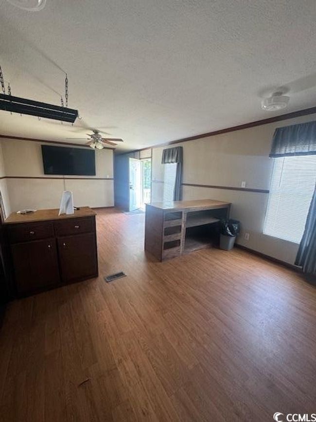 Bedroom with wood finished floors | Image 6