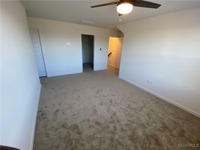 Unfurnished bedroom featuring carpet flooring, baseboards, and ceiling fan | Image 28