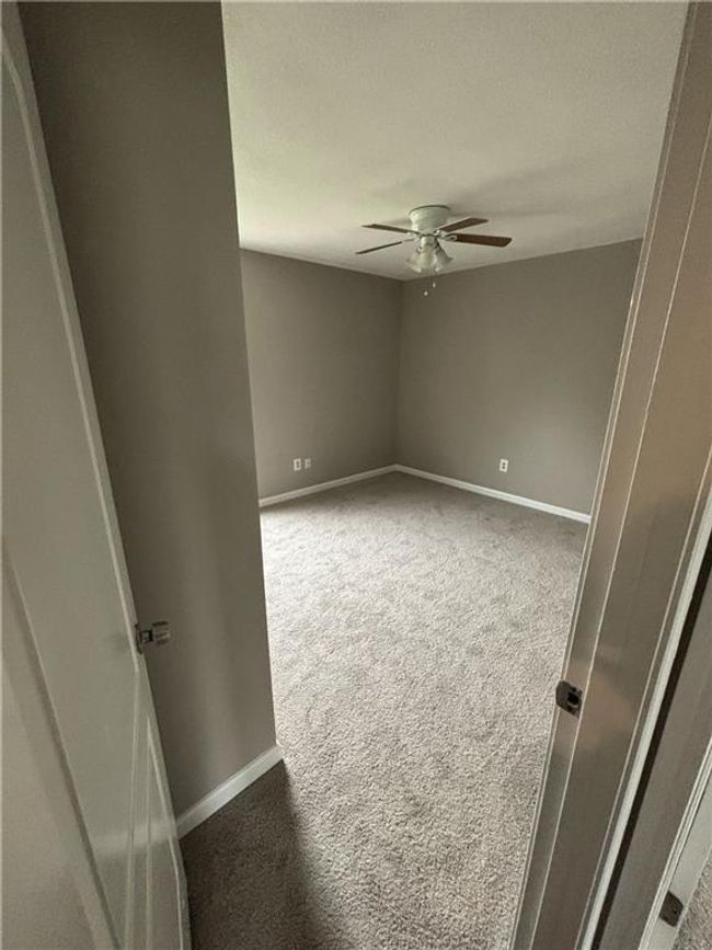 Carpeted spare room with baseboards, ceiling fan, and a textured ceiling | Image 21