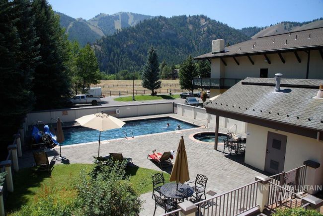 View of swimming pool with a mountain view, a patio, and outdoor dining area | Image 19