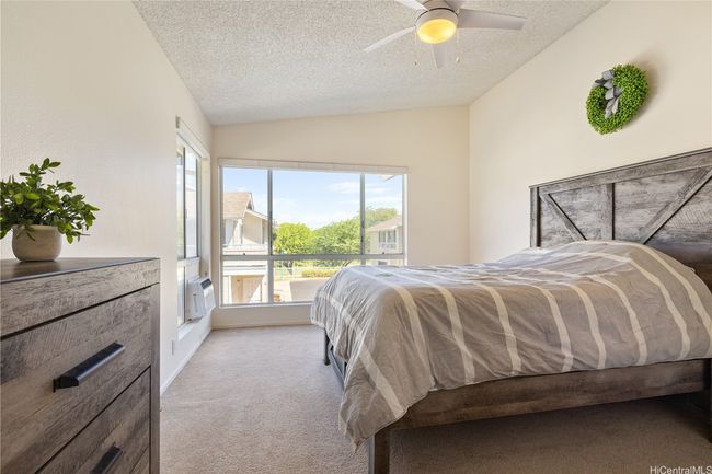 Large windows and vaulted ceilings in the spacious primary bedroom with en suite bathroom. Includes upgraded roller shades for privacy. | Image 18