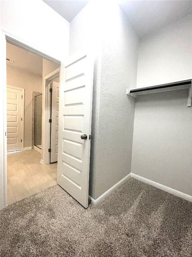 Spacious closet with light colored carpet | Image 14