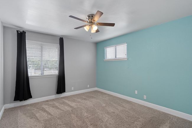 Carpeted spare room with a ceiling fan and baseboards | Image 22