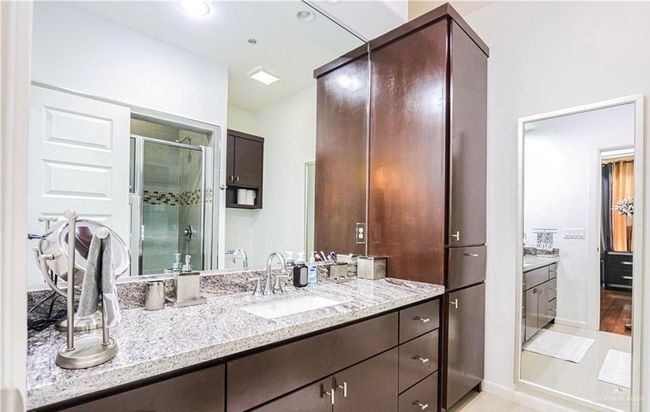 Bathroom featuring vanity and a shower with door | Image 11