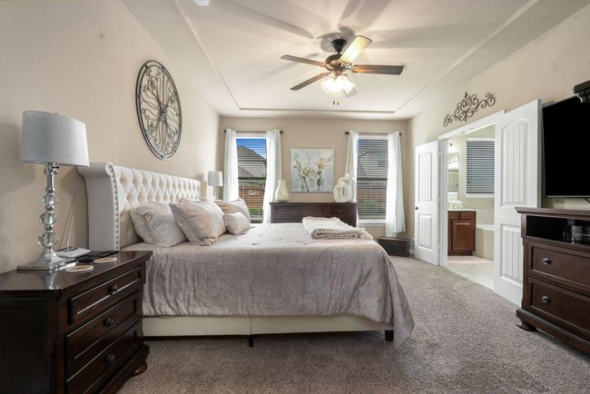Carpeted bedroom featuring ensuite bath and a ceiling fan | Image 16