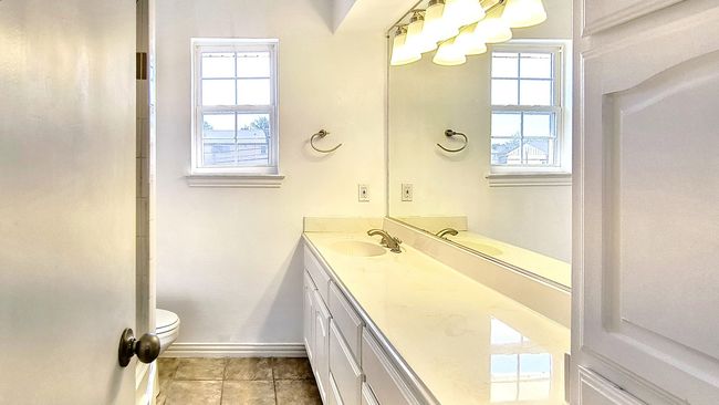 Bathroom with vanity, tile patterned flooring, and toilet | Image 28