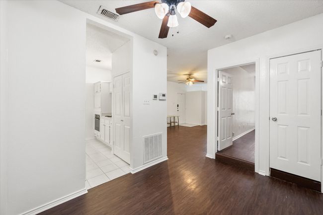 Unfurnished room with a ceiling fan, light wood-style flooring, and a textured ceiling | Image 10