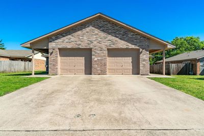 View of front of house featuring a garage and a front lawn | Image 1