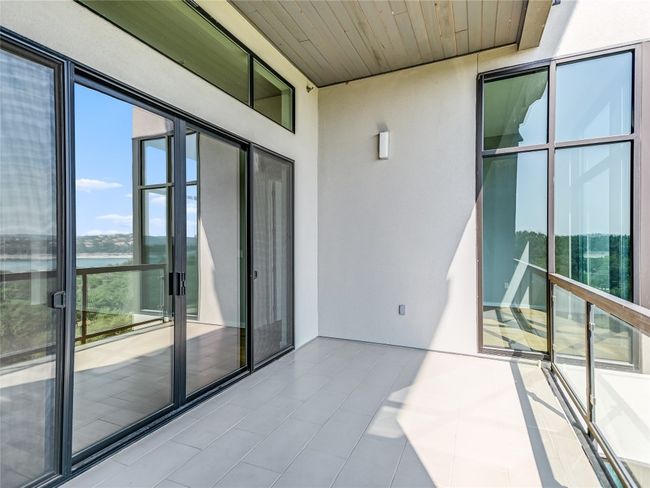 Enjoy cool breezes from the north through the screen doors. The other wall on the balcony is cable wired for your wall-mount TV! | Image 15