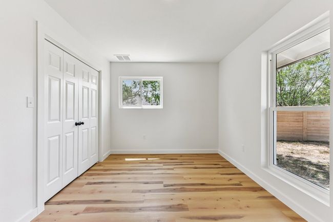 Unfurnished bedroom with light wood finished floors and a closet | Image 25