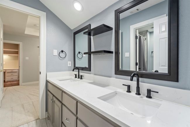 Bathroom with double vanity and vaulted ceiling | Image 9