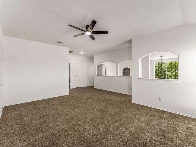 Spare room with ceiling fan and dark carpet | Image 27