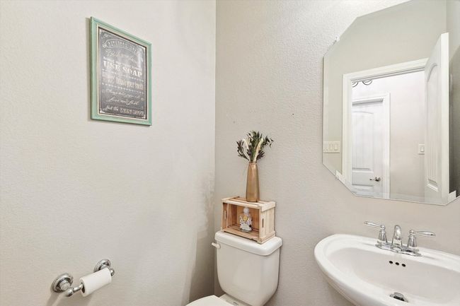 Bathroom featuring a sink and toilet | Image 14