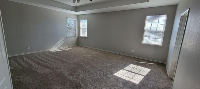 Unfurnished room with healthy amount of natural light, carpet flooring, and a raised ceiling | Image 10