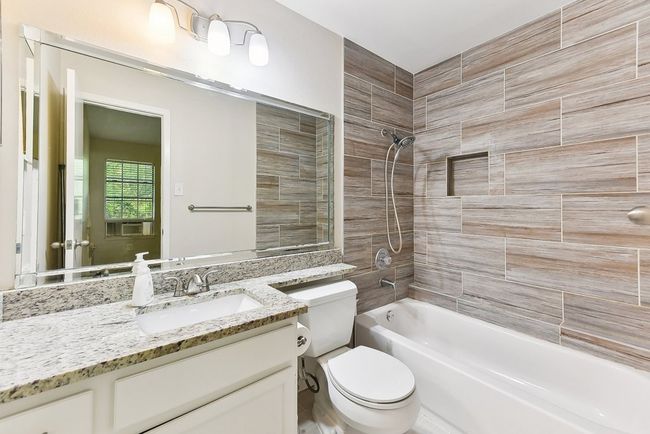 Bathroom with toilet, vanity, and shower / bathtub combination | Image 24