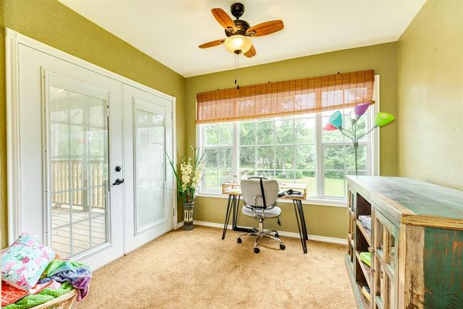 Sitting room off of the primary bedroom, with double doors leading out to a private porch. | Image 15