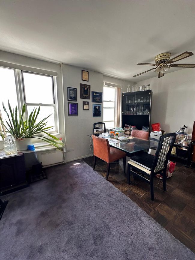 Carpeted dining space with a ceiling fan | Image 15
