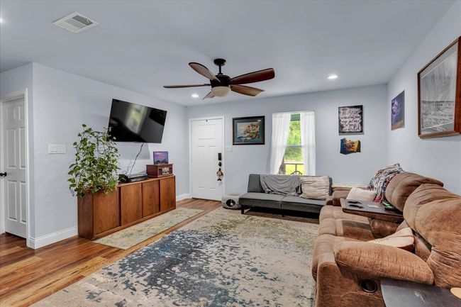 Living area with wood finished floors, a ceiling fan, and recessed lighting | Image 7