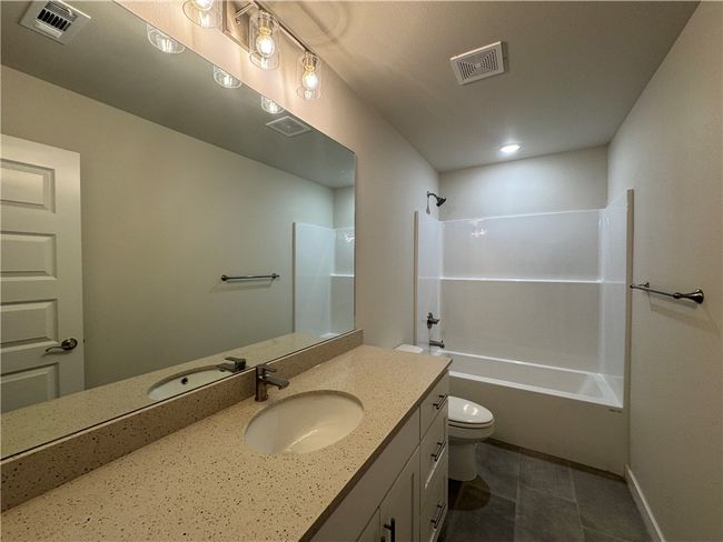 The full bathroom is a serene oasis, adorned with modern fixtures and finishes, providing a relaxing space to rejuvenate and unwind. | Image 17