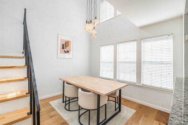 Dining area featuring stairs, baseboards, and plenty of natural light | Image 6