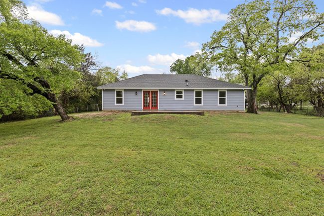 Back of house featuring french doors, a yard, and a shingled roof | Image 26