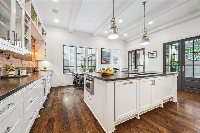 KITCHEN. Note the two sets of doors which open out onto the pool garden and windows overlooking the kitchen garden. Imagine cooking in here and having those doors flung open on a Spring day. | Image 9