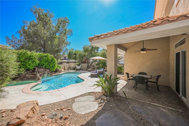 View of pool featuring a a covered patio area with a ceiling fan | Image 60