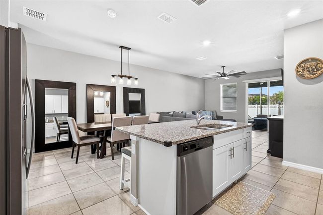 Dining area has overhead lighting fixture and room for a table of 6+. | Image 10
