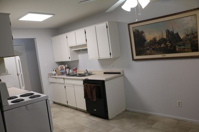 Kitchen featuring white range with electric stovetop, light countertops, a ceiling fan, white cabinets, and dishwasher | Image 14