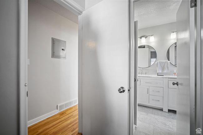 Hallway featuring electric panel and baseboards | Image 11