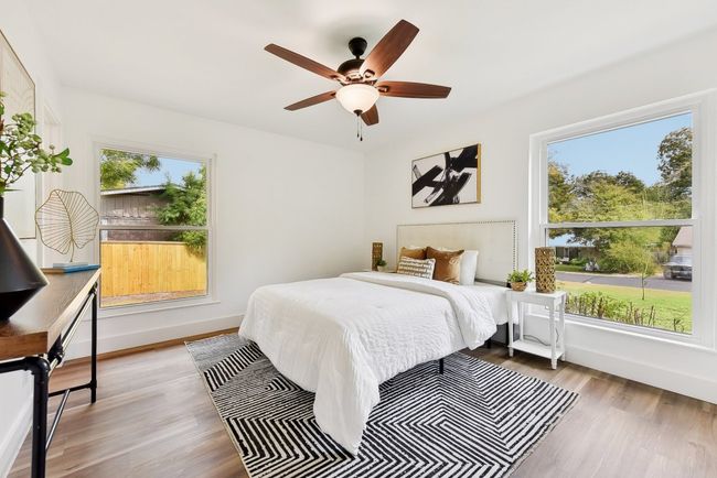 Bedroom featuring multiple windows, baseboards, and wood finished floors | Image 16