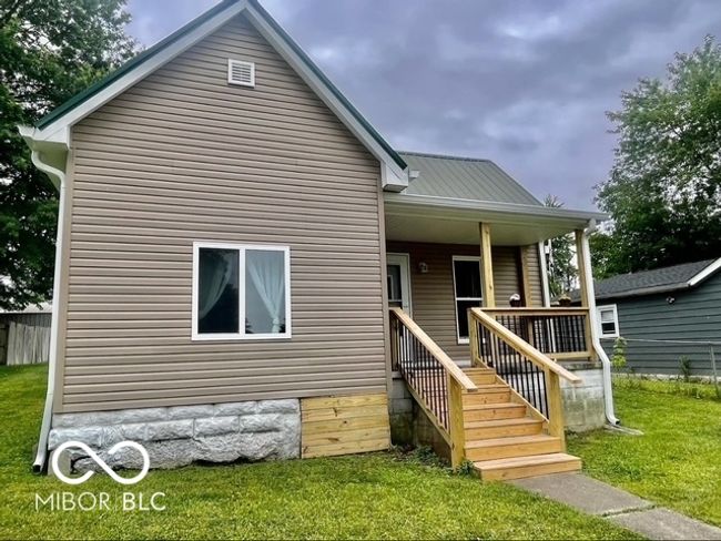 back of house featuring covered porch and a yard | Image 11