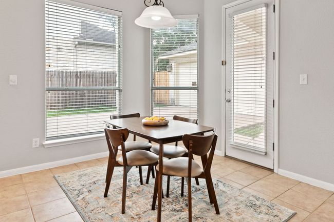Dining room featuring healthy amount of natural light and light tile patterned floors | Image 14