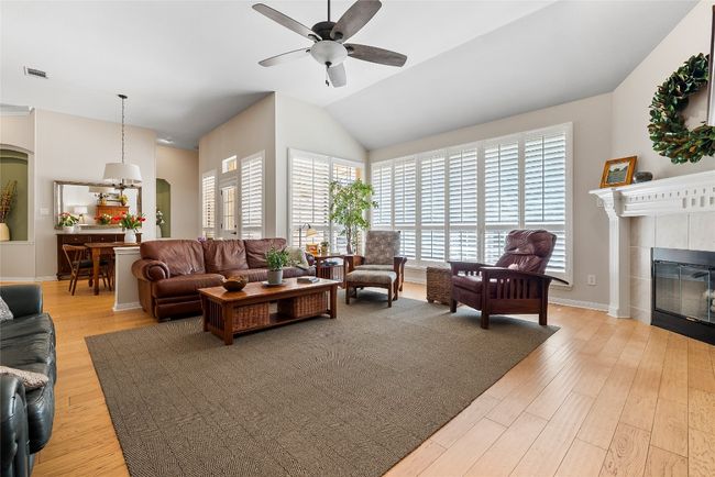 A cozy fireplace anchors the room, providing a perfect focal point for relaxing evenings or intimate gatherings | Image 10