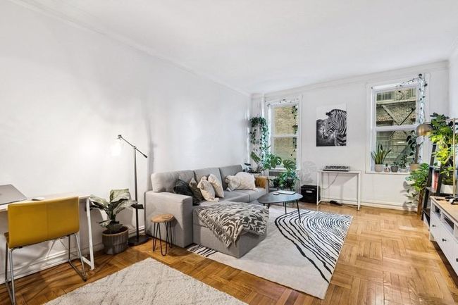 Living area with a wealth of natural light and ornamental molding | Image 4