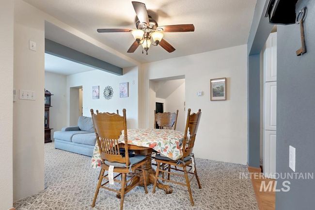 Dining area featuring a ceiling fan and light wood-style flooring | Image 17