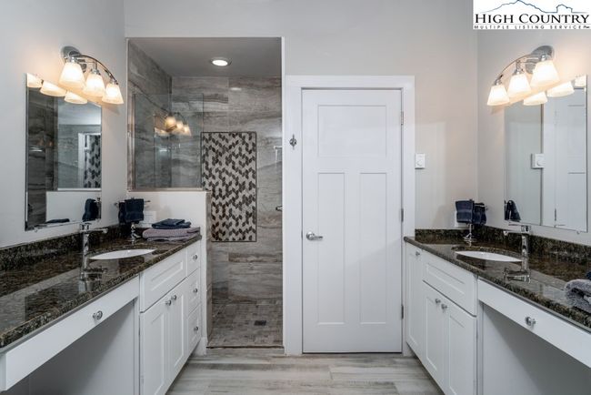 Double vanity, walk in tile shower. | Image 15