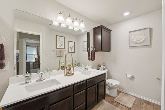 Bathroom with double vanity and wood finished floors | Image 20