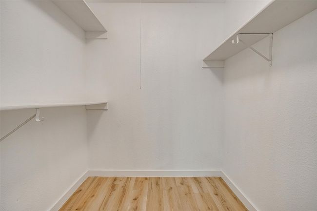 Spacious closet featuring light wood finished floors | Image 24