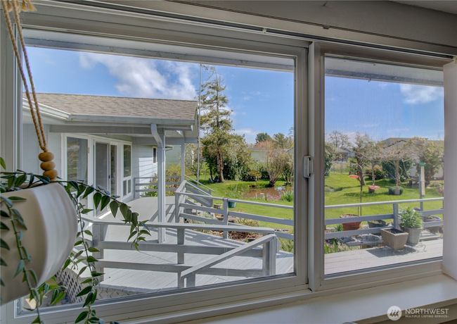The view from the kitchen window looking into the fenced back yard and deck. | Image 17