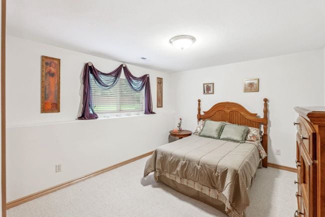 Carpeted bedroom with baseboards | Image 16