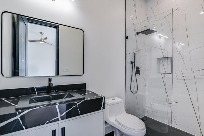 Full bath with a marble finish shower and vanity | Image 30
