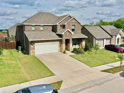 View of front of house featuring a front lawn, a garage, and central AC unit | Image 2