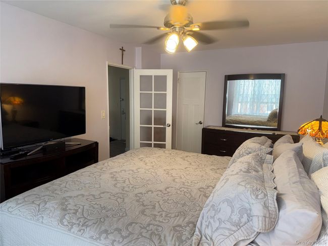 Bedroom featuring a ceiling fan | Image 7