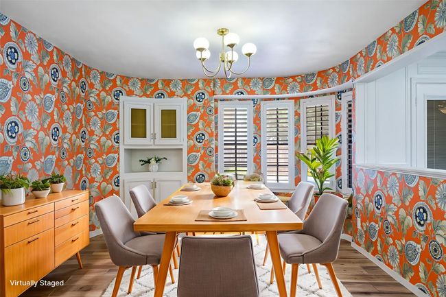 Dining space featuring wallpapered walls, a chandelier, and light wood-style flooring | Image 4