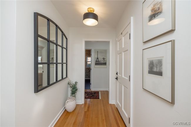 Hallway featuring baseboards and light wood finished floors | Image 4