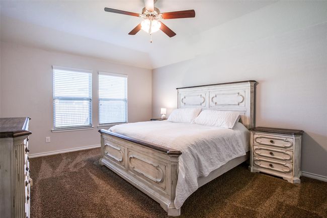 Bedroom with dark colored carpet and ceiling fan | Image 13