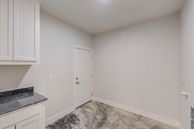 Laundry room with baseboards | Image 28