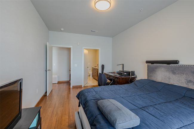 Bedroom featuring light wood-style flooring and ensuite bathroom | Image 18